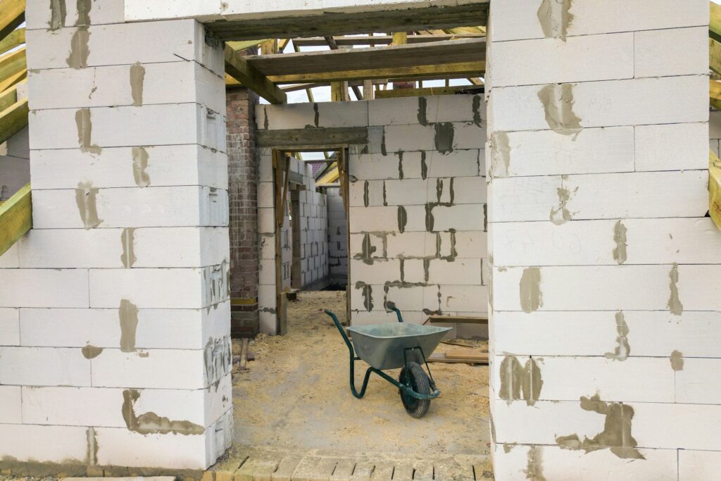 Interior of a private house with aerated concrete brick walls and wooden frame for future roof